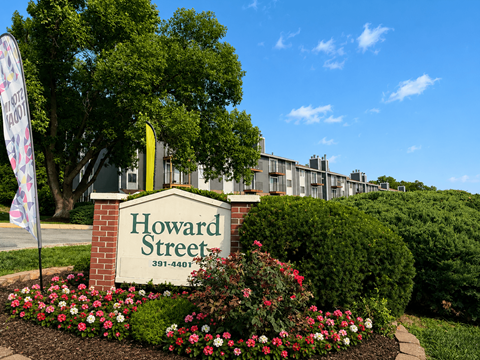 A sign that says Howard Street in front of a building.