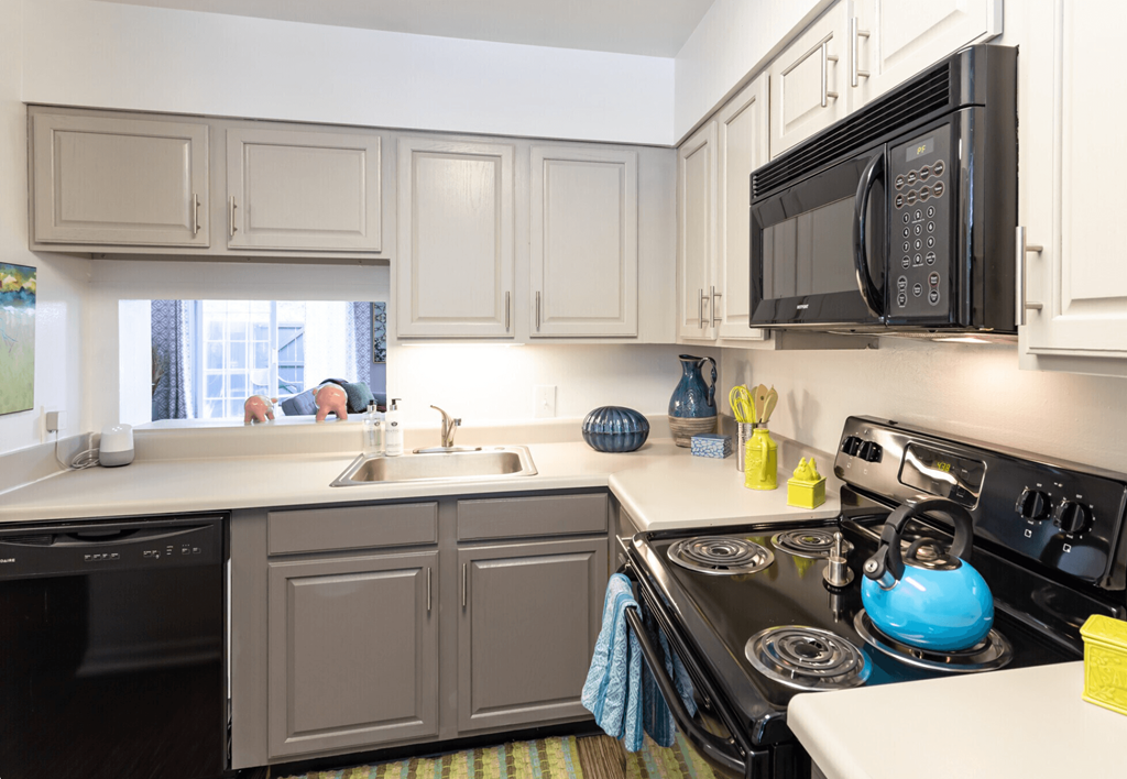 A kitchen with a black microwave above a black stove.