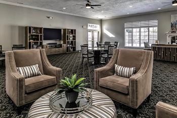 a living room with two chairs and a table