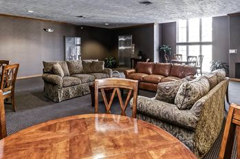 a living room with couches and chairs and a table