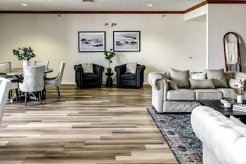 a living room with a couch and chairs and a table