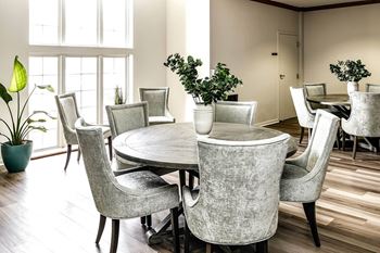 a dining room with a round table and chairs