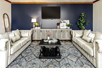 a living room with blue walls and white couches