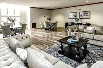 a living room with couches and chairs and a table