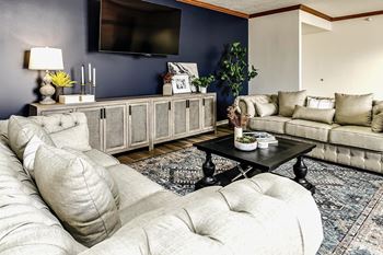 a living room filled with furniture and a tv