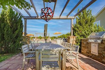 a dining area with a table and chairs on a patio
