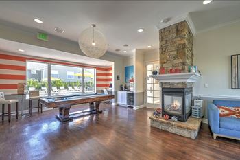 a game room with a pool table and a fireplace