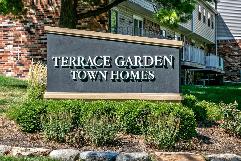 a sign for the terrace garden town homes in front of a building