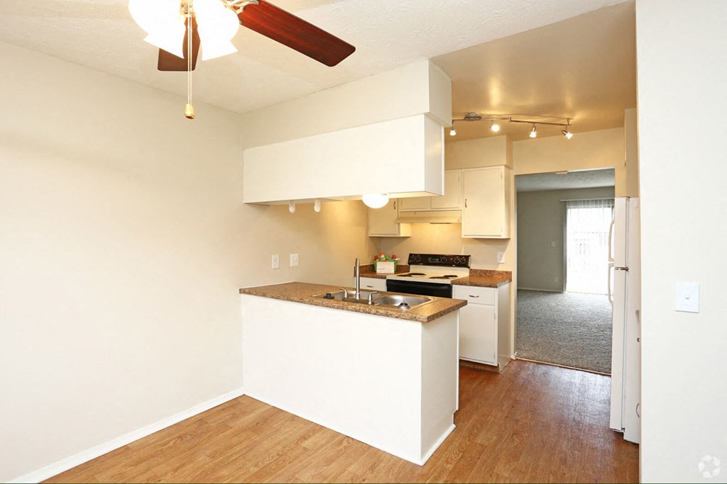 a kitchen with white cabinets and a counter top