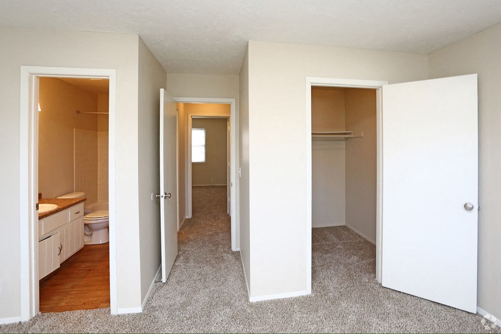 a view of a bedroom and a bathroom from the living room