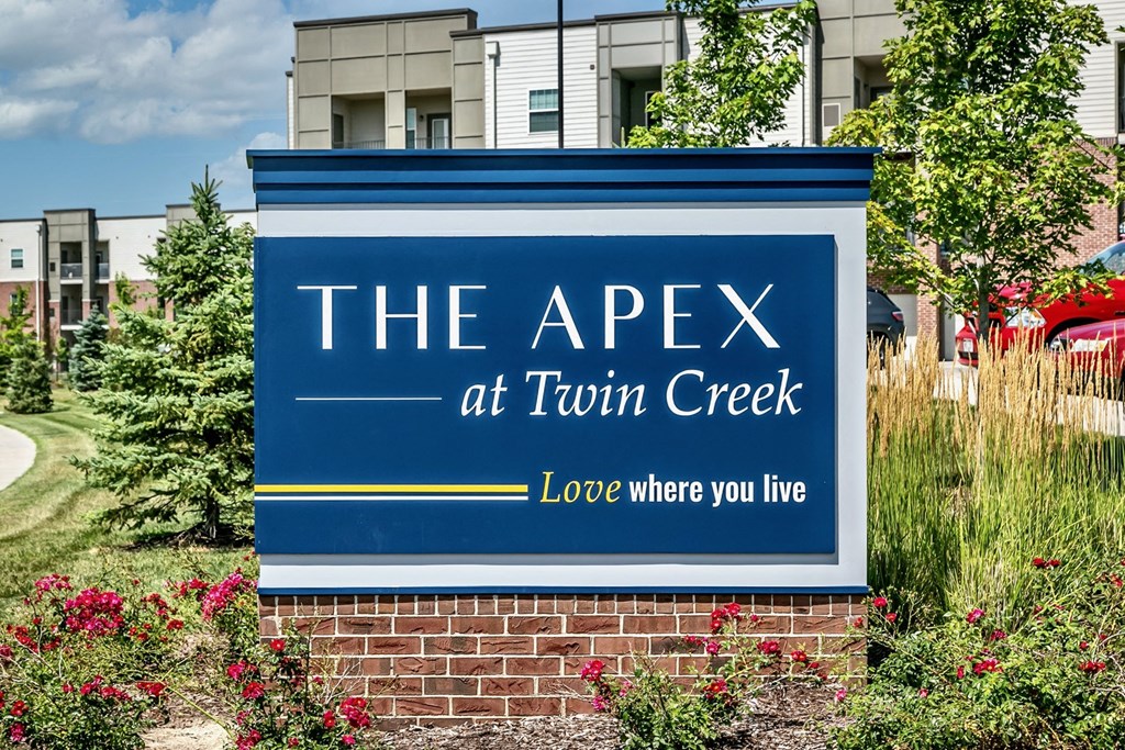 the apex at torn creek apartment sign in front of building