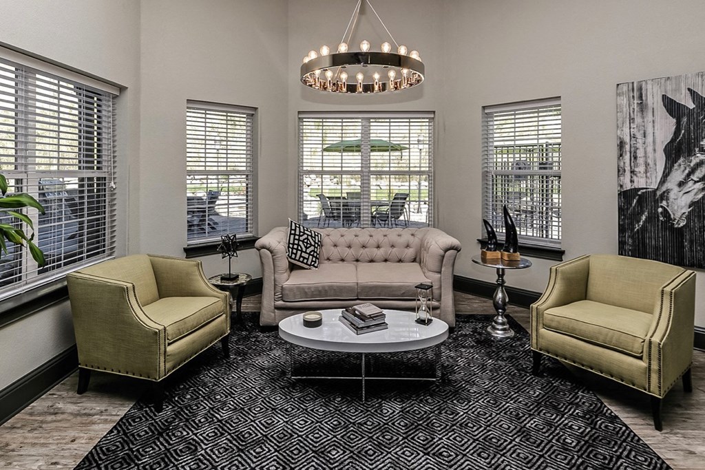 a living room with a couch and chairs and a coffee table