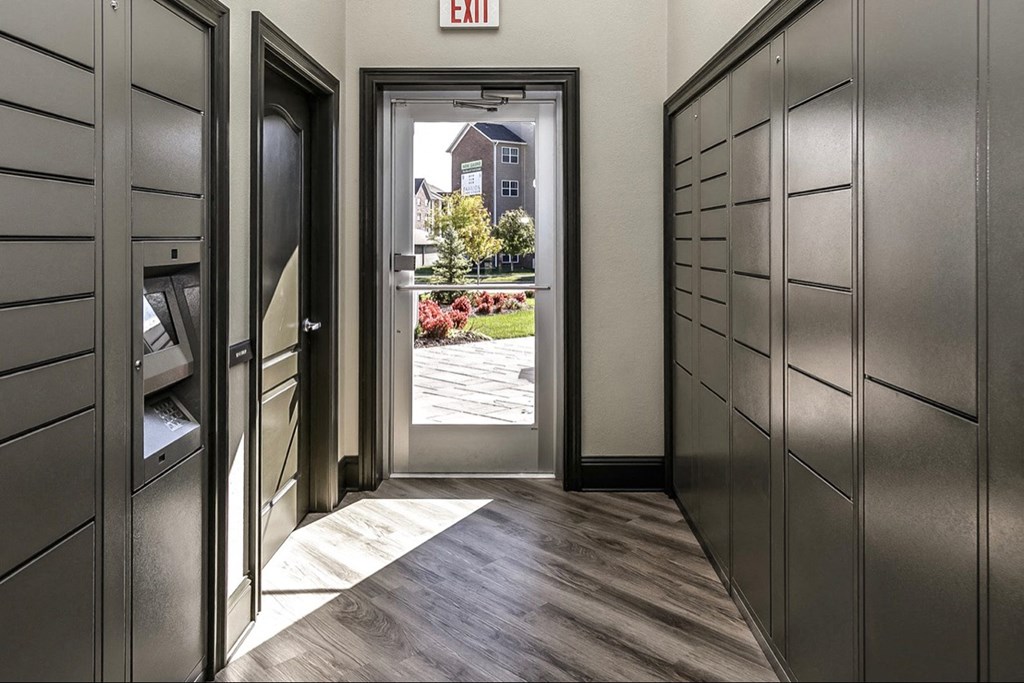 a hallway with a door to a house with a yard and a window