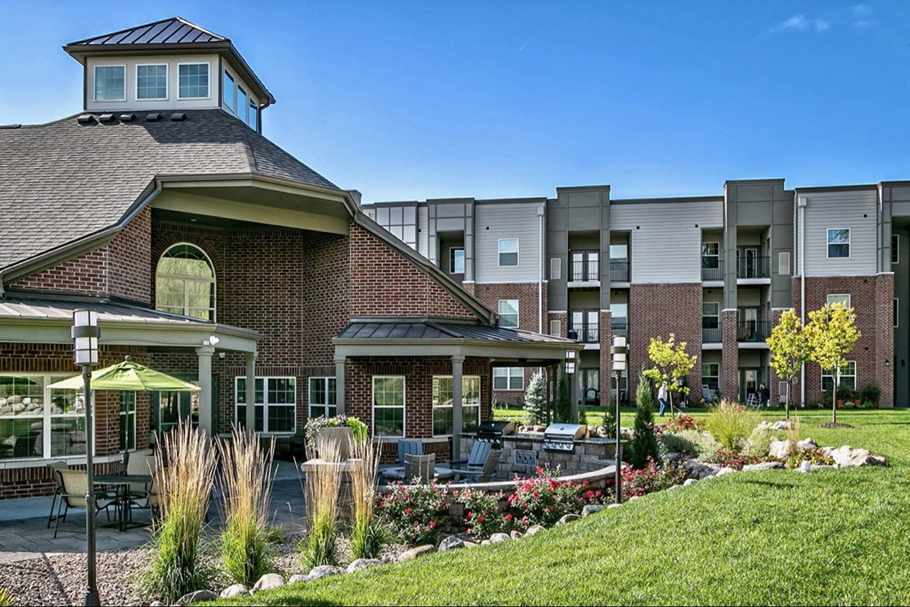 an exterior view of a building with tables and chairs