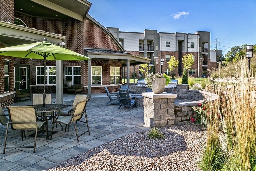 a patio with tables and chairs and a fountain