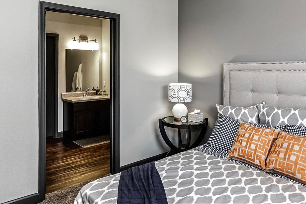 a bedroom with a large mirror and a bed