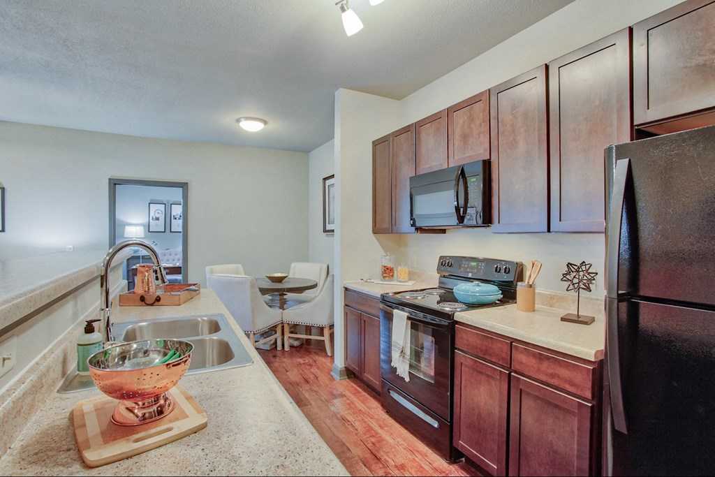 a kitchen with stainless steel appliances and wooden cabinets