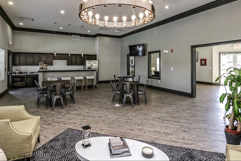 a clubhouse with tables and chairs and a kitchen