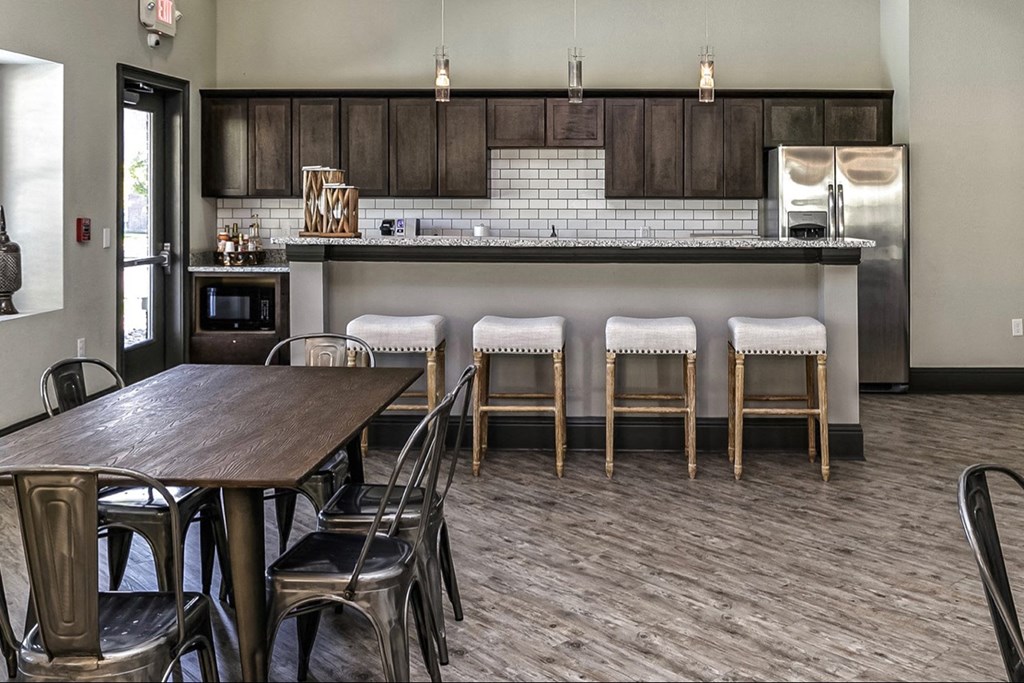 a dining room with a table and chairs and a kitchen