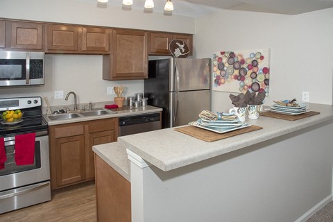 a kitchen with stainless steel appliances and wooden cabinets