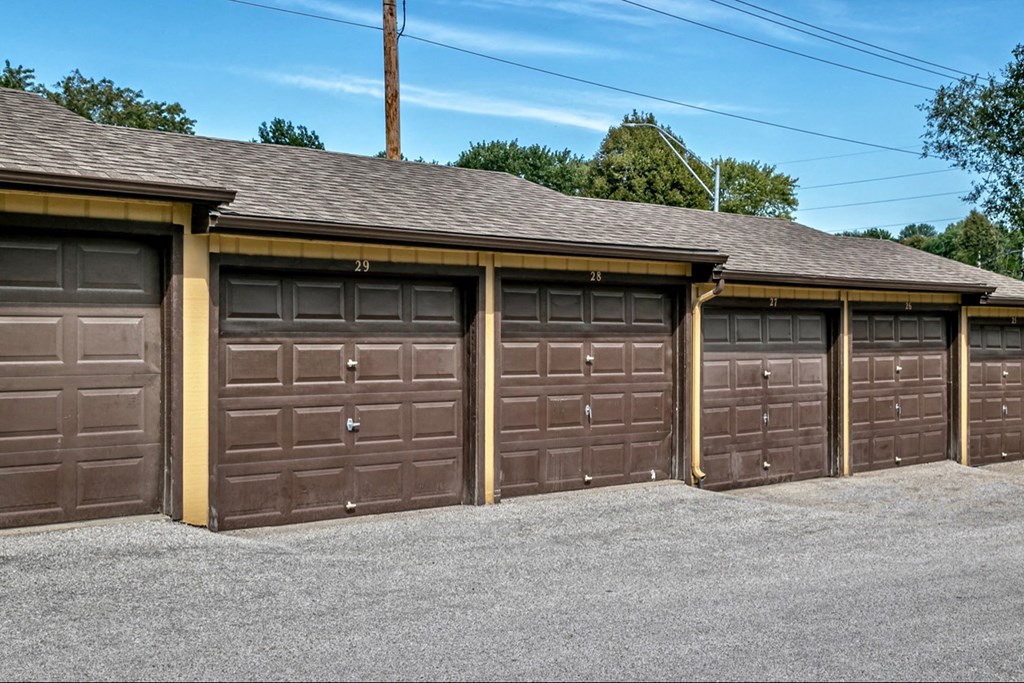 a row of garages with brown garage doors