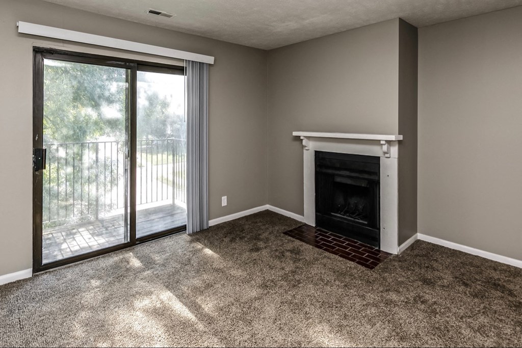 a living room with a fireplace and a sliding glass door