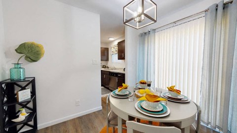 A dining room with a table set for two.