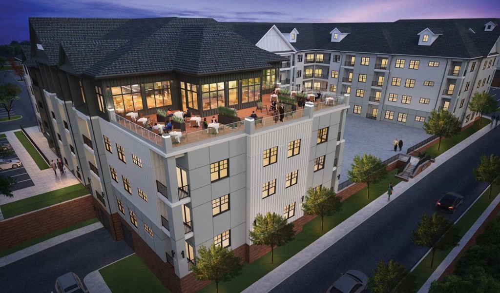 A large, modern building with a lot of windows and a spacious courtyard.