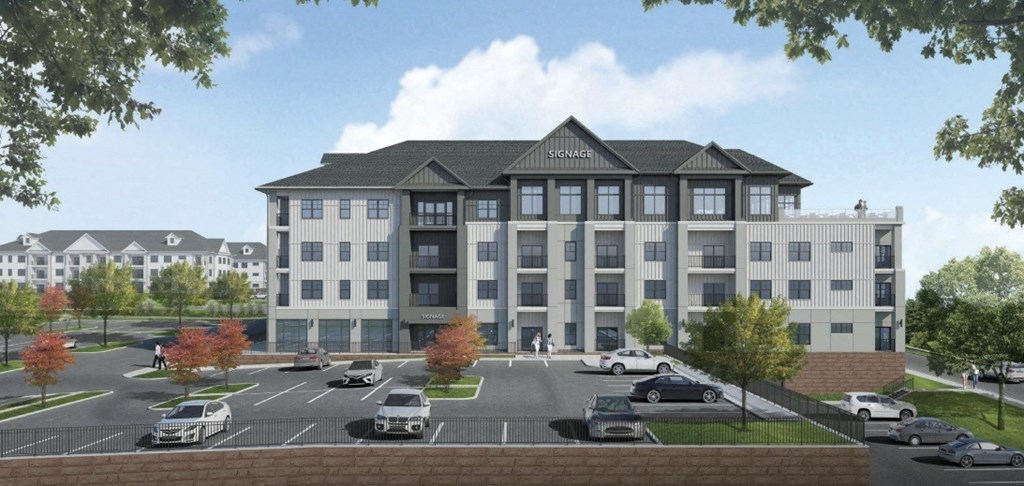 A large, modern building with a parking lot in front.