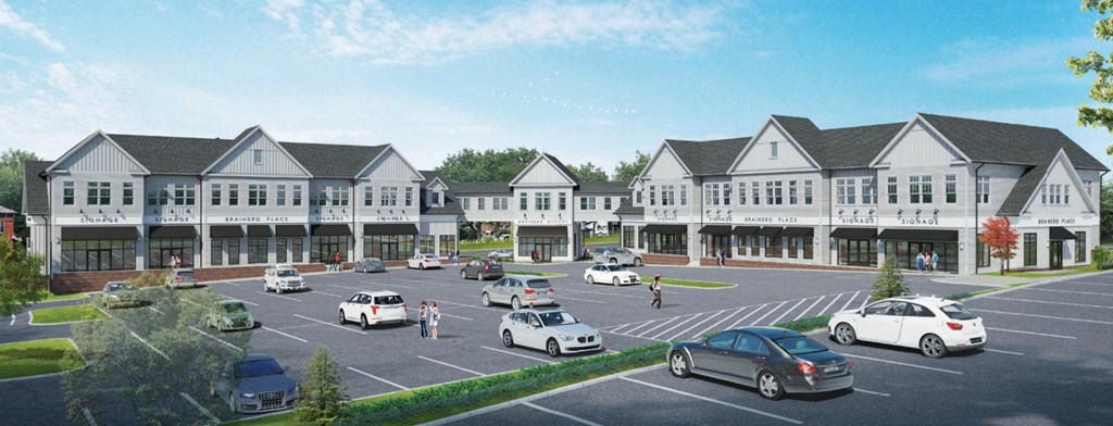 A large, modern building with a parking lot in front.