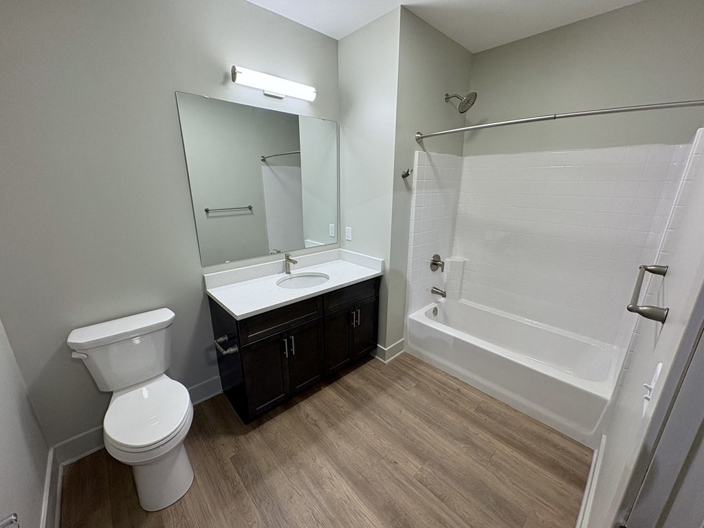 A white toilet sits next to a sink in a bathroom.