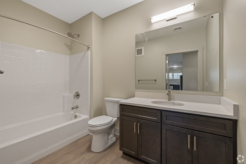 A white bathroom with a toilet, sink, and bathtub.