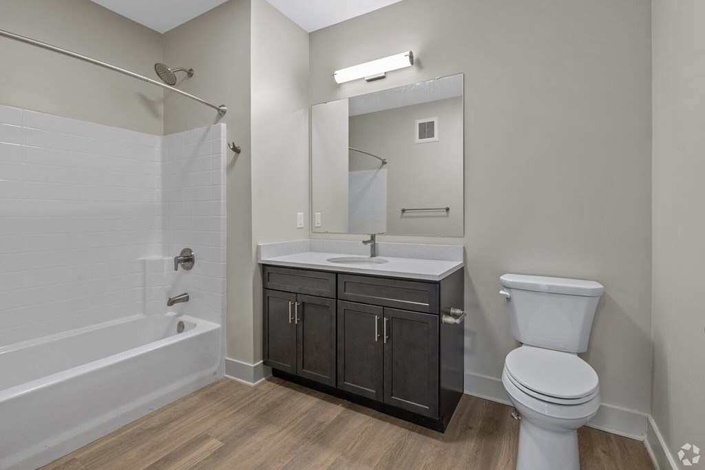 A bathroom with a white toilet, a white sink, and a white bathtub.