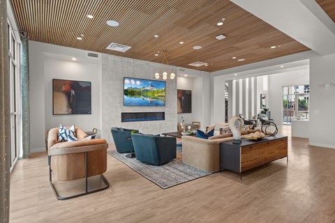 A modern living room with a wooden ceiling and a large painting on the wall.
