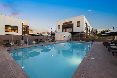 A large swimming pool in front of a modern building.