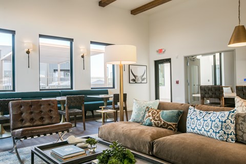 A living room with a brown couch and a coffee table.
