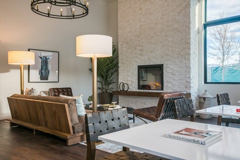 A living room with a fireplace and a book titled "The Art of Fashion Months".