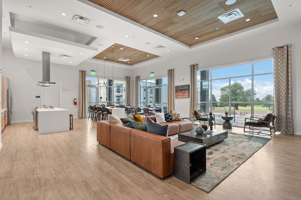 A modern living room with a wooden floor and a large window.