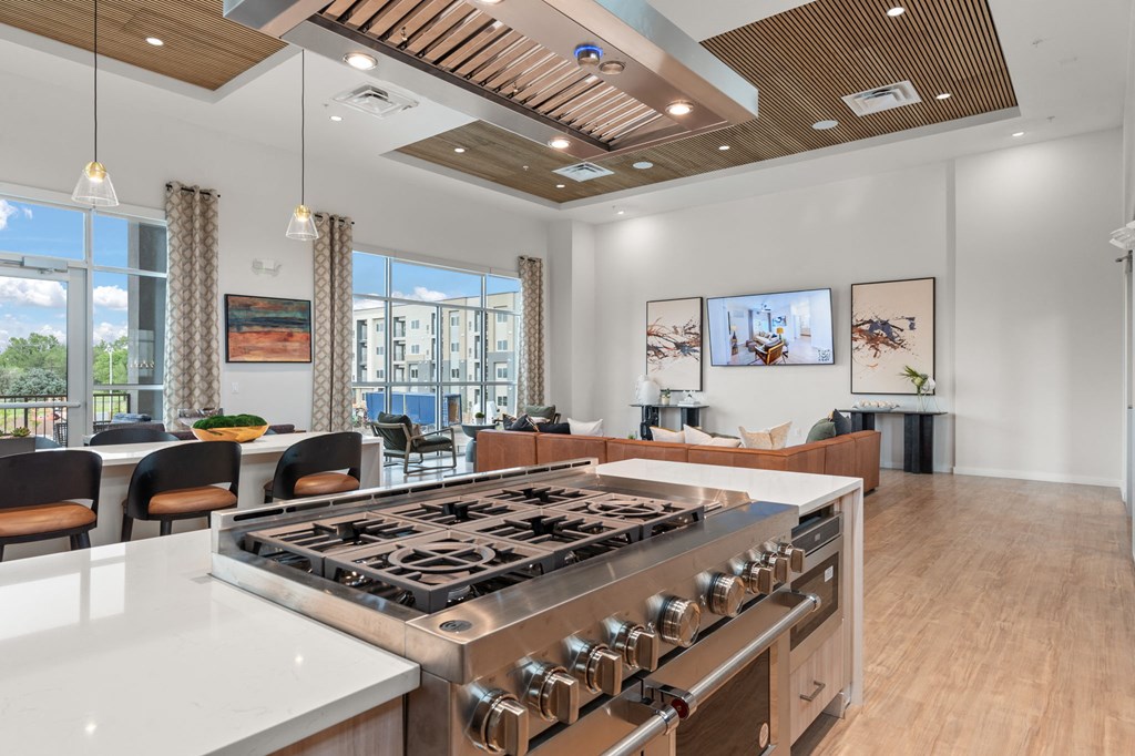 A modern kitchen with a large island and a stove top oven.