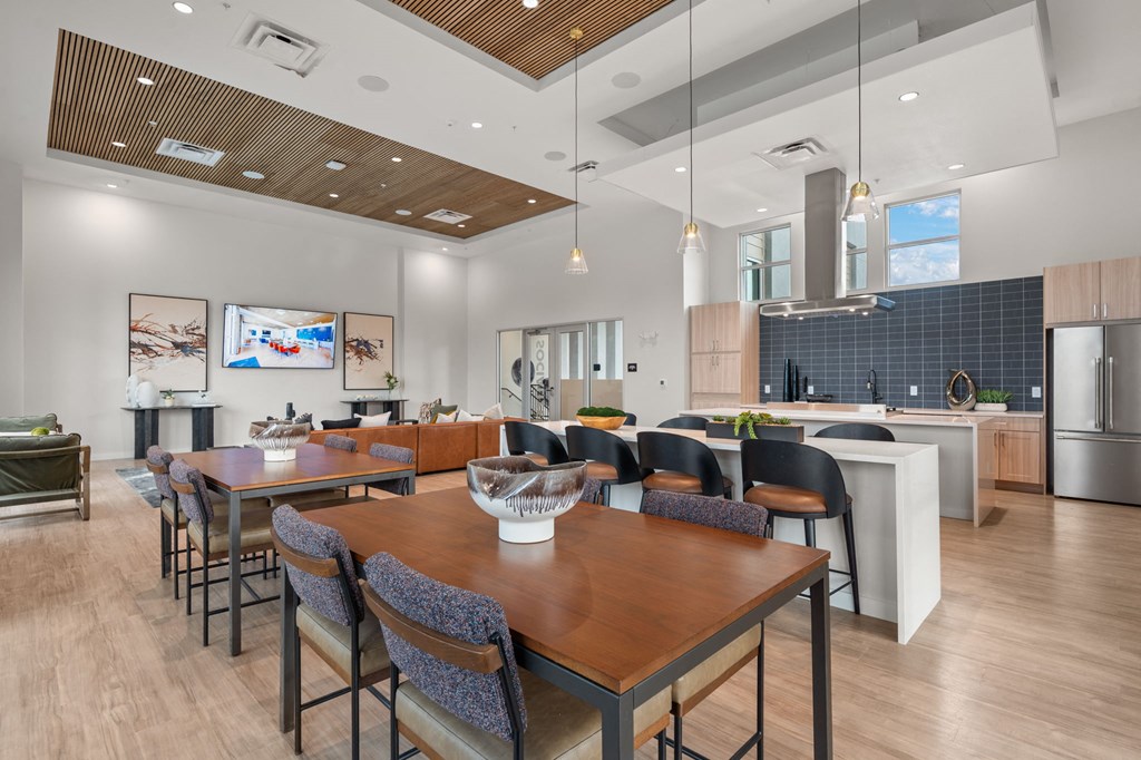 A modern dining room with a wooden table and chairs.