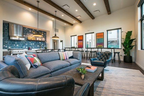 A living room with a blue couch and a coffee table.