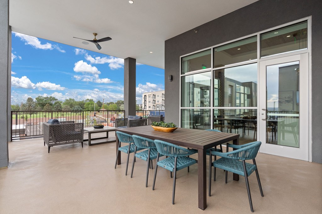 A table with chairs is set up on a patio.