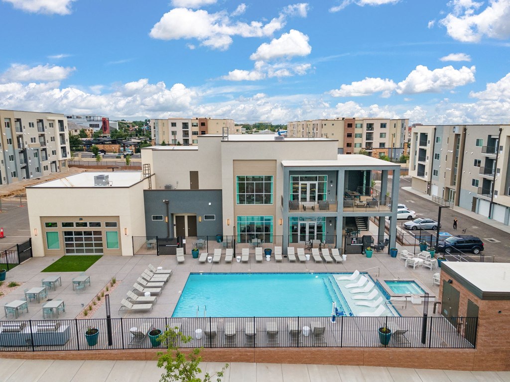 A large building with a pool in front of it.