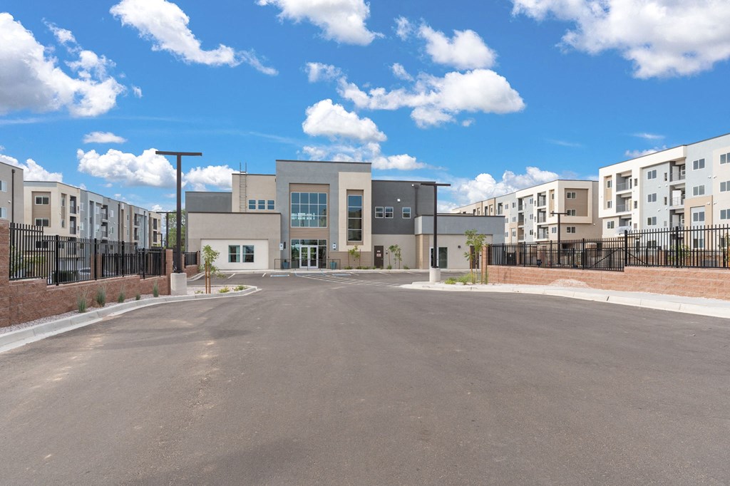 A large building with a parking lot in front of it.