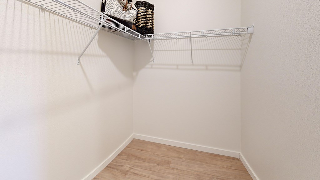 A white wire shelf with a few items on it.