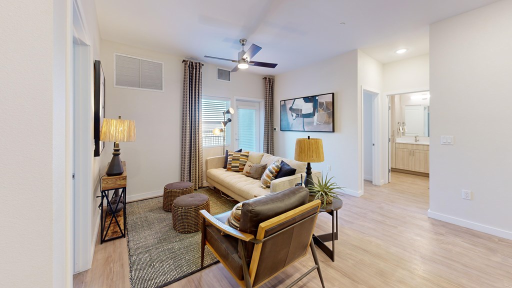 A living room with a brown leather couch and a wooden coffee table.