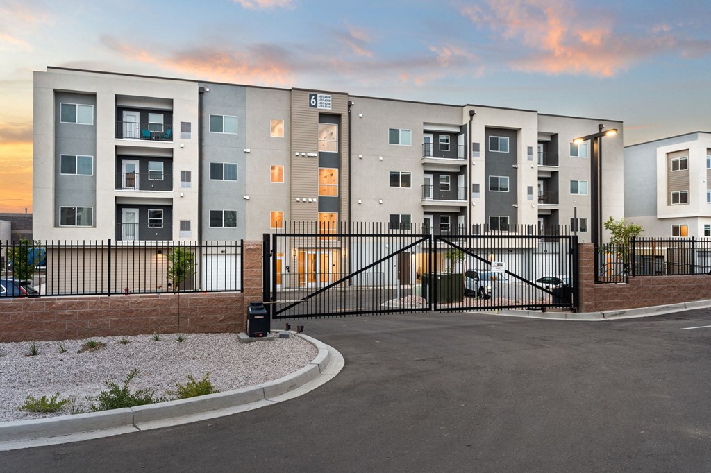 A modern apartment complex with a gated entrance.