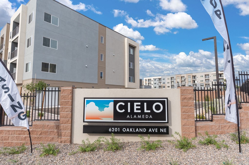 A sign for Cielo Alameda stands in front of a building.