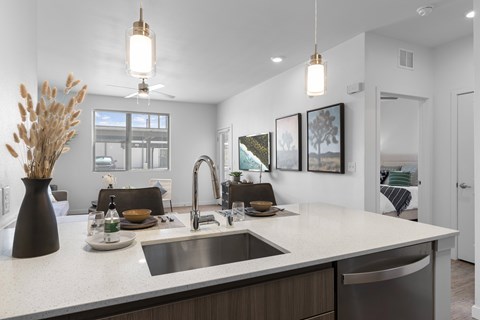 A modern kitchen with a large island and a sink.