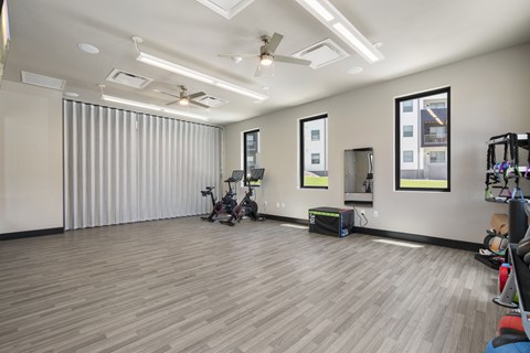 A room with a wooden floor and a ceiling fan.
